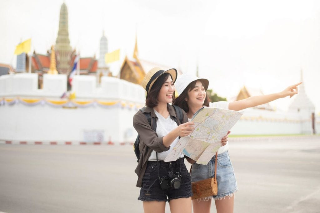 2 girls walking and pointing 