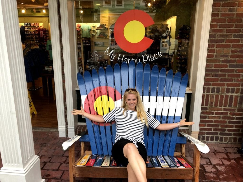 trip around the world- me sitting in a cute Colorado chair made from skis!