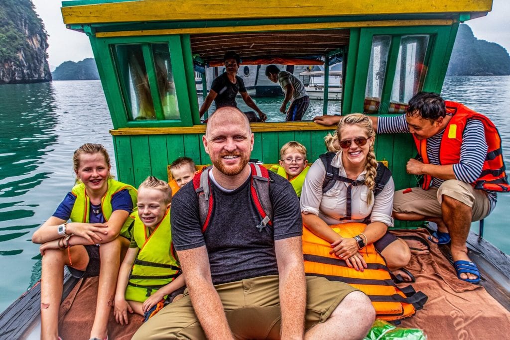 trip around the world- family picture on a green and yellow boat in Halong Bay