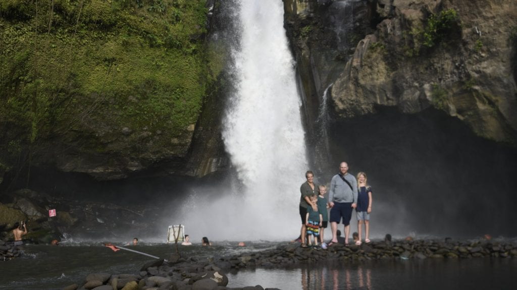 Family picture in front of a huge Bali waterfall 