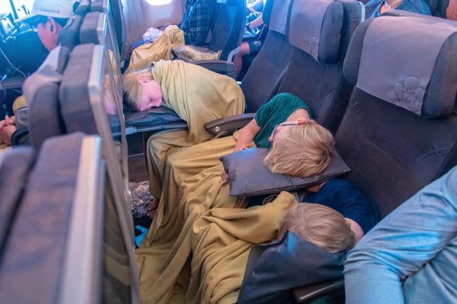 Three of the kids asleep on the plane