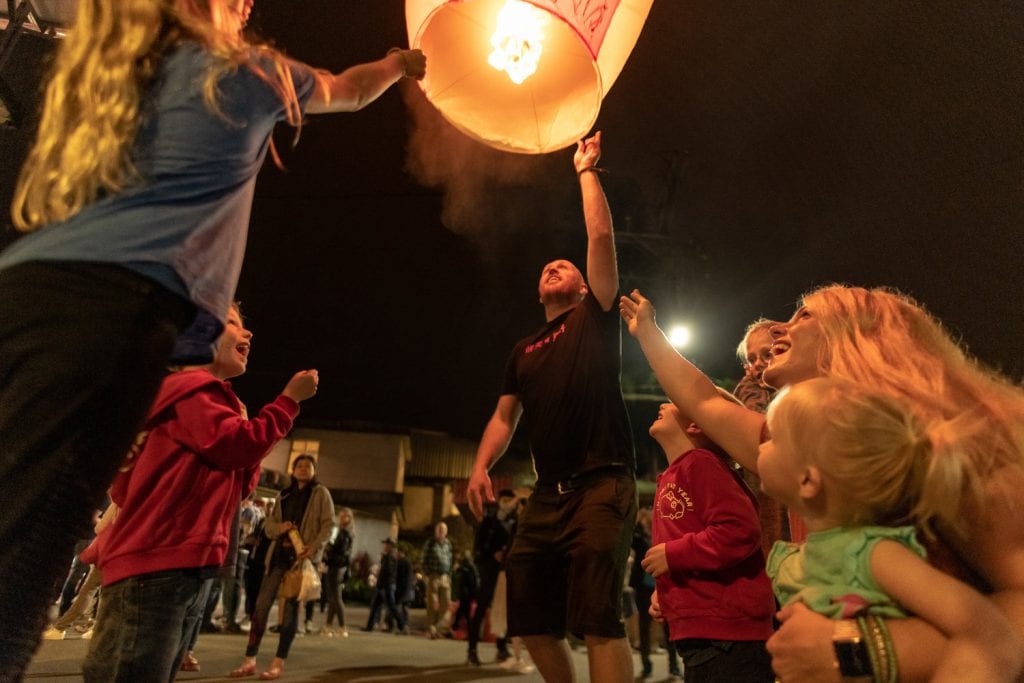 Chris helping the kids release a lantern into the sky